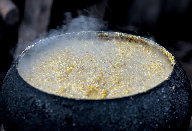 Steaming porridge in a cast iron cauldron. Traditional big metal pot stock images, royalty-free photos and pictures