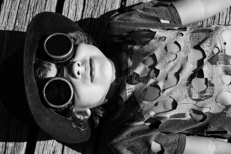 Steampunk kid playing on the bridge, in hat google ant t-hshirt. Perspective ant stock images, royalty-free photos and pictures