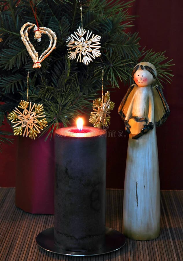 Angel, burning candle and Christmas ornaments. Angel, burning candle and Christmas ornaments