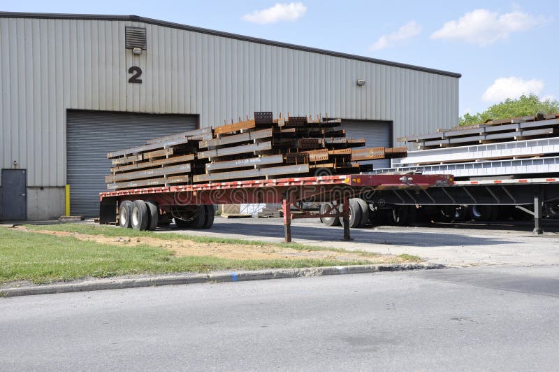 Steel beams on trucks royalty free stock photography