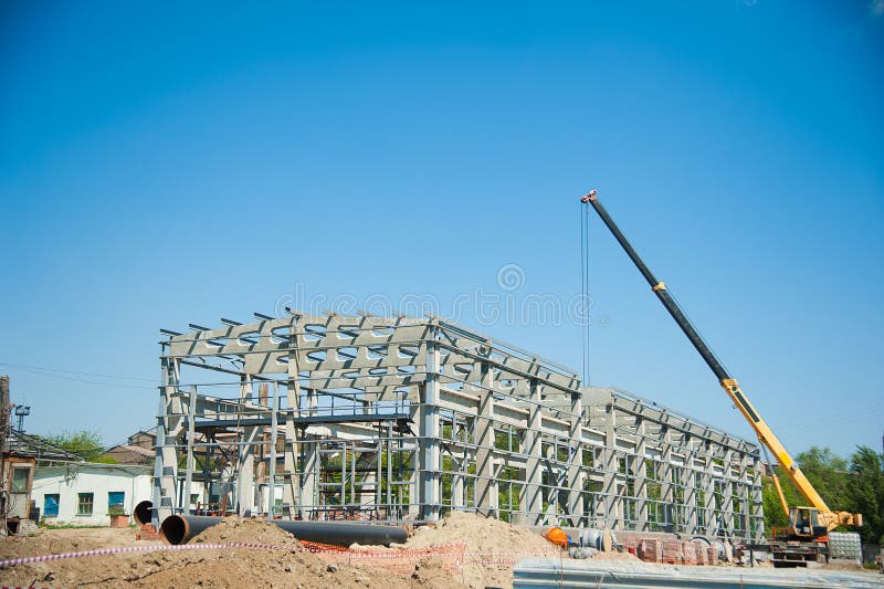 Steel Frame is Under Construction Against a Blue Sky Stock