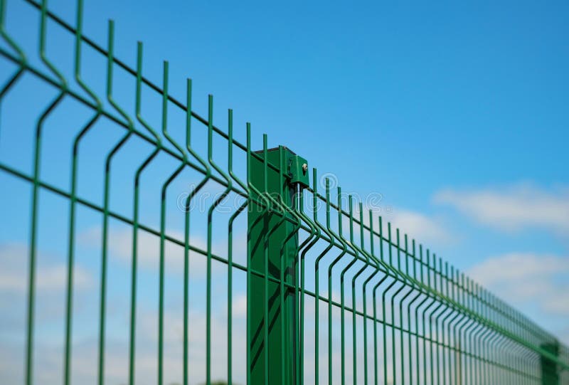 Steel grating fence made with wire on blue sky background. Sectional fencing installation.