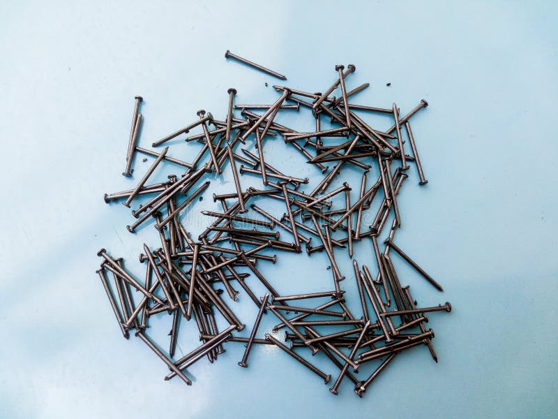 Steel Nails Isolated on Blue Background. Metal Tool for Construction