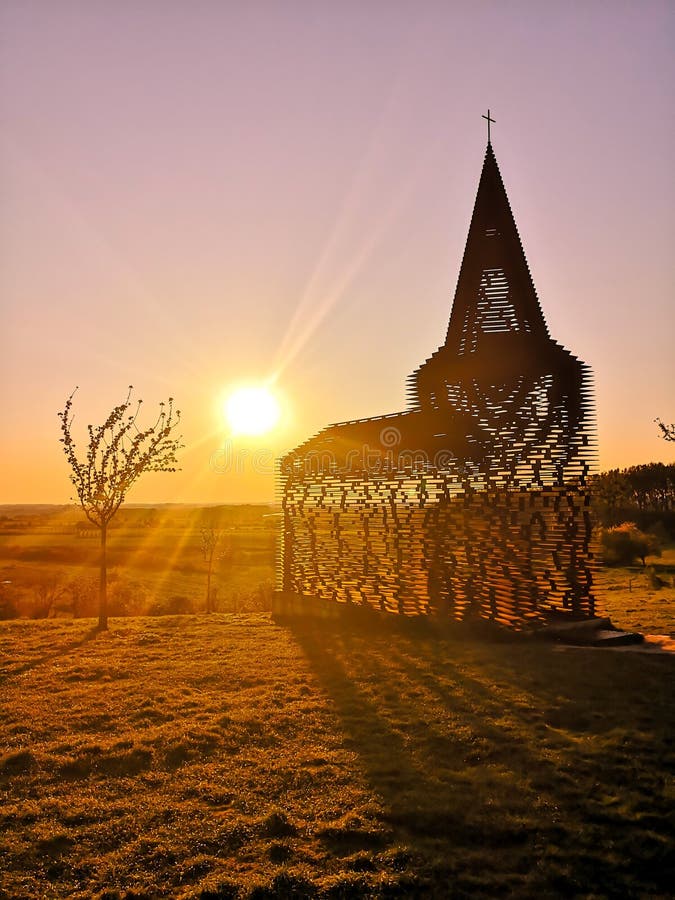 Steel see-through church in Borgloon Hesbaye, Belgium, known as the art project Reading between the lines, during sunset. royalty free stock photos Steel see-through church in Borgloon Hesbaye, Belgium, known as the art project Reading between the lines, during sunset. royalty free stock photos