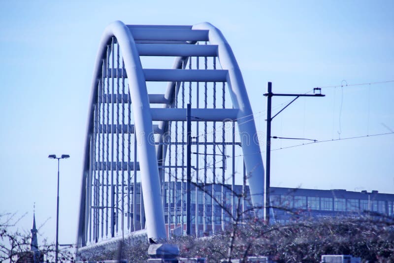 Steel suspension bridge over Motorway A12 named Nootdorpboog. This bridge is created for the NS Railways to go maintenance plant i stock photography Steel suspension bridge over Motorway A12 named Nootdorpboog. This bridge is created for the NS Railways to go maintenance plant i stock photography