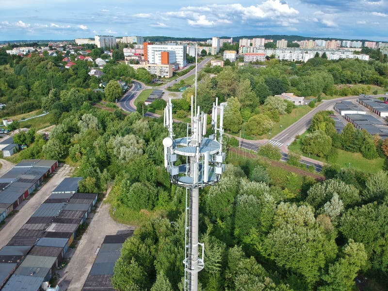 Steel telecommunication tower in the middle of city with forest, aerial view. stock photography Steel telecommunication tower in the middle of city with forest, aerial view. stock photography