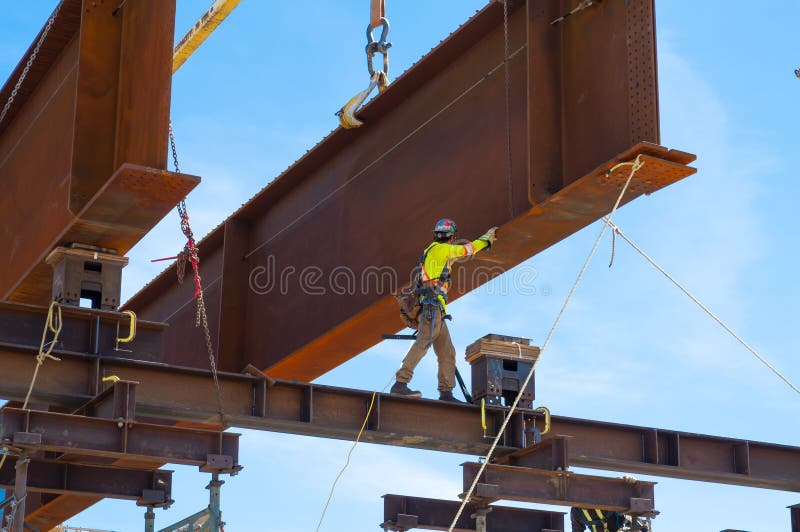 A Steel Working Guiding a 3 Meter High Steel Bridge Girder into Place ...