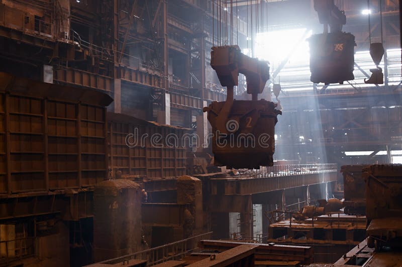 Steelmaking ladles on crane hanging on steel mill. Smelting metal in a metallurgical plant. Steelmaking ladles on crane hanging on steel mill royalty free stock photography Steelmaking ladles on crane hanging on steel mill. Smelting metal in a metallurgical plant. Steelmaking ladles on crane hanging on steel mill royalty free stock photography