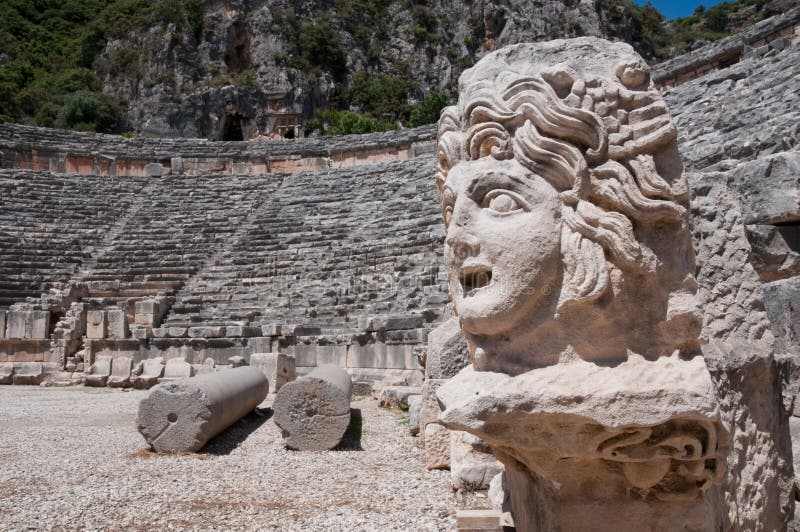 Stone mask and ancient amphitheater, Myra, Turkey. Stone mask and ancient amphitheater, Myra, Turkey