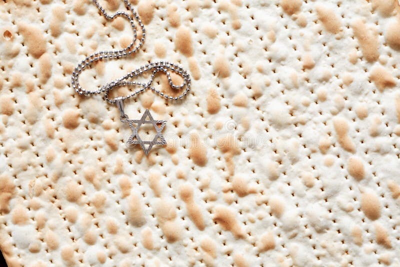 Seder concept. Star of David symbol lying on matzah background. Seder concept. Star of David symbol lying on matzah background