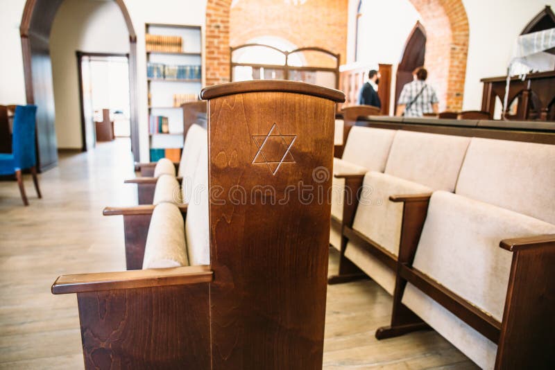 Star of David, Jewish symbol on wooden bench or chair in synagogue, close up. Star of David, Jewish symbol on wooden bench or chair in synagogue, close up