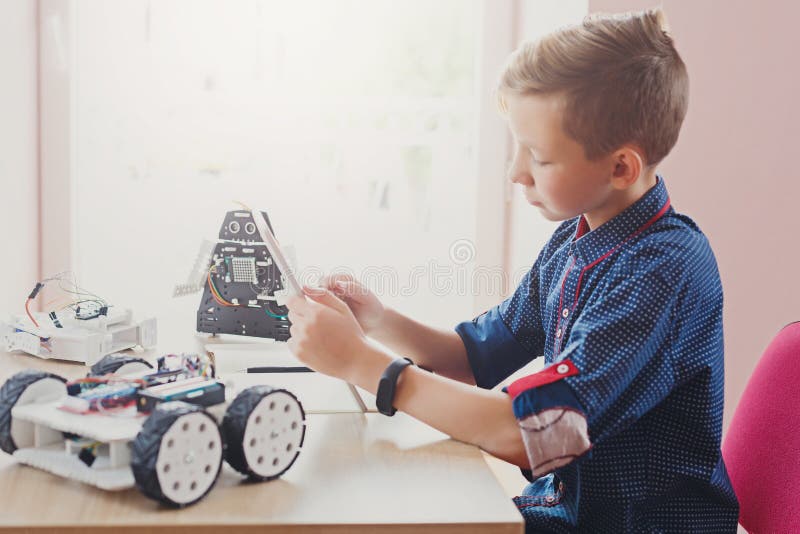Stem education. Boy creating robot at lab royalty free stock photo
