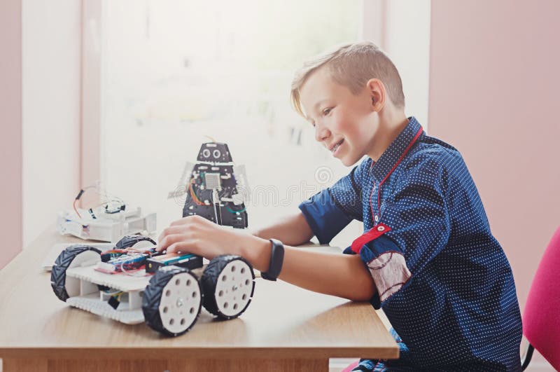 Stem education. Boy creating robot at lab royalty free stock images