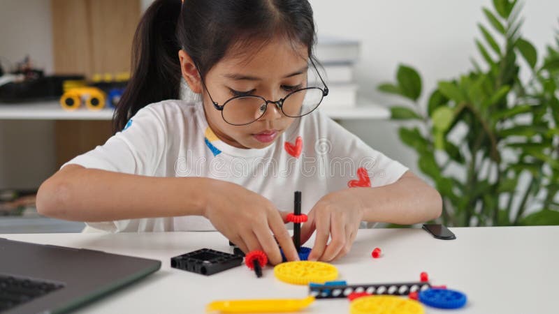 STEM education concept. Asian home school girls self-study online lessons and are excited to make STEM toys. mathematics royalty free stock image