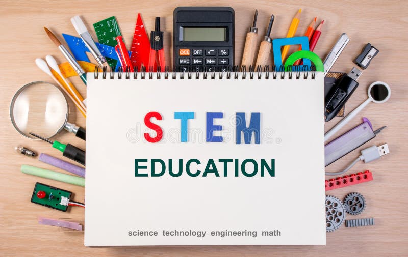 STEM education text on notebook over school supplies or office s stock images