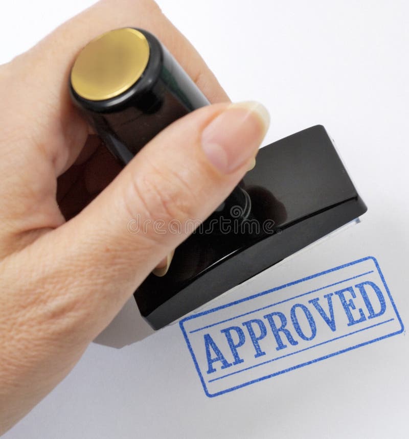 Rubber stamp in a hand (on a light background). Rubber stamp in a hand (on a light background)