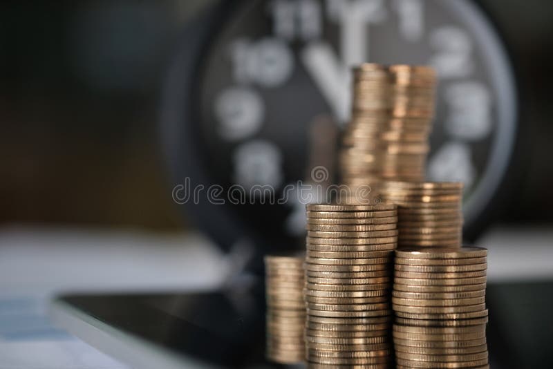 Step of coins stacks and alarm clock with tablet computer and financial graph, business planning vision and finance analysis concept idea.