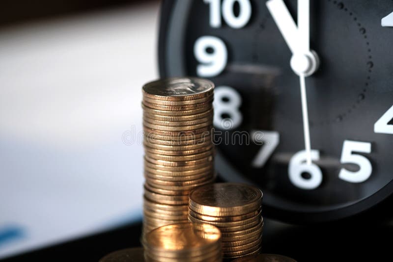 Step of coins stacks and alarm clock with tablet computer and financial graph, business planning vision and finance analysis concept idea.