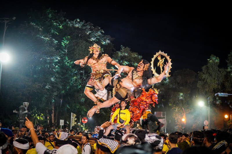 Step into the heart of Balinese tradition with this captivating snapshot of the Ogoh-Ogoh parade in Catur Muka,Denpasar,Bali. As the rhythmic beat of drums fills the air,larger-than-life mythological figures come to life,each intricately crafted to embody ancient tales and spiritual forces. Against the backdrop of the vibrant sunset,the parade unfolds like a moving canvas of colors,emotions,and collective energy. This photograph encapsulates the essence of cultural devotion,as the community unites to honor their roots and propel these mesmerizing creations through the streets,bringing a surge of artistic,spiritual,and communal vitality to the heart of Bali. Step into the heart of Balinese tradition with this captivating snapshot of the Ogoh-Ogoh parade in Catur Muka,Denpasar,Bali. As the rhythmic beat of drums fills the air,larger-than-life mythological figures come to life,each intricately crafted to embody ancient tales and spiritual forces. Against the backdrop of the vibrant sunset,the parade unfolds like a moving canvas of colors,emotions,and collective energy. This photograph encapsulates the essence of cultural devotion,as the community unites to honor their roots and propel these mesmerizing creations through the streets,bringing a surge of artistic,spiritual,and communal vitality to the heart of Bali.