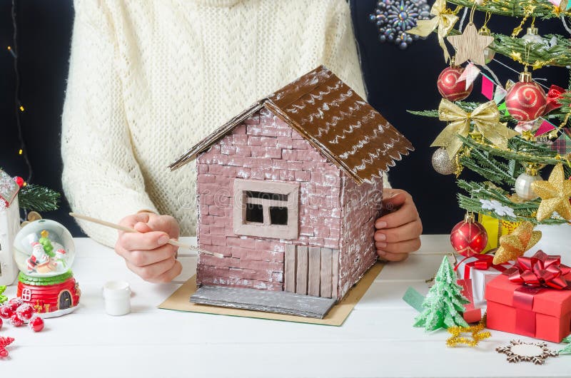 Step-by-step photo instructions for making a Christmas decor, step 9 -  ready-made painted cardboard house Stock Photo - Alamy