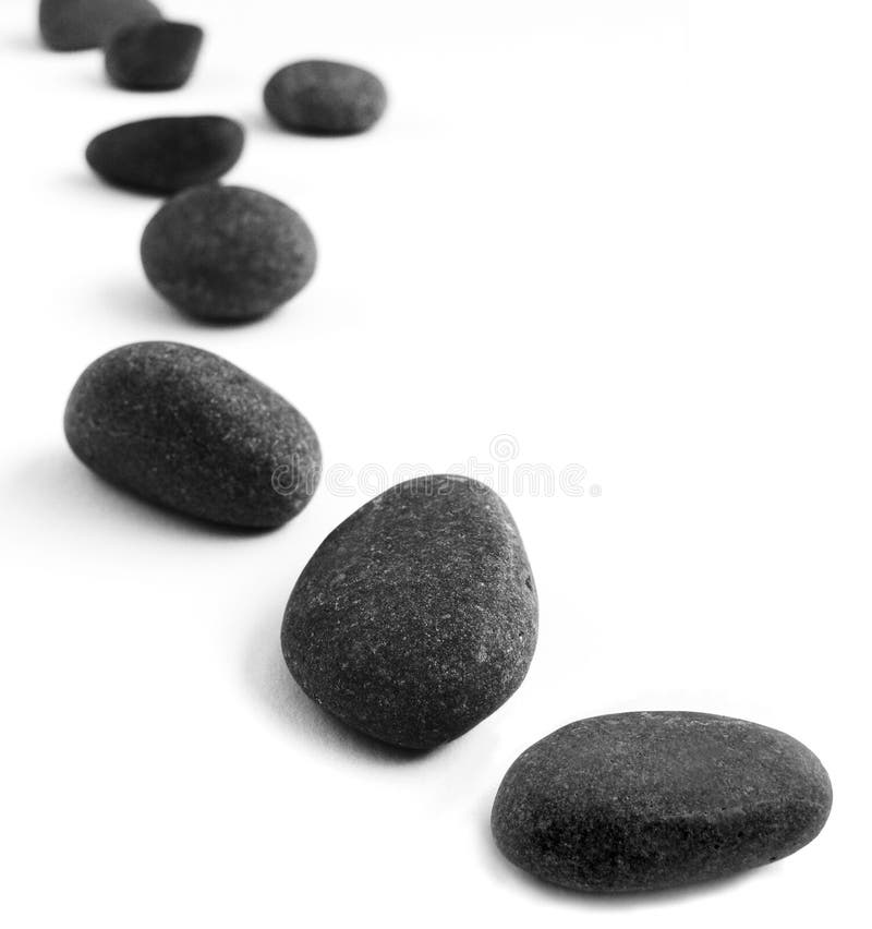 An image of a still life arrangement of dark gray pebbles, placed to resemble some stepping stones leading from the foreground into the distance. Concept picture of taking steps towards a goal or target. Clean white background with copyspace for text, words, etc. An image of a still life arrangement of dark gray pebbles, placed to resemble some stepping stones leading from the foreground into the distance. Concept picture of taking steps towards a goal or target. Clean white background with copyspace for text, words, etc.