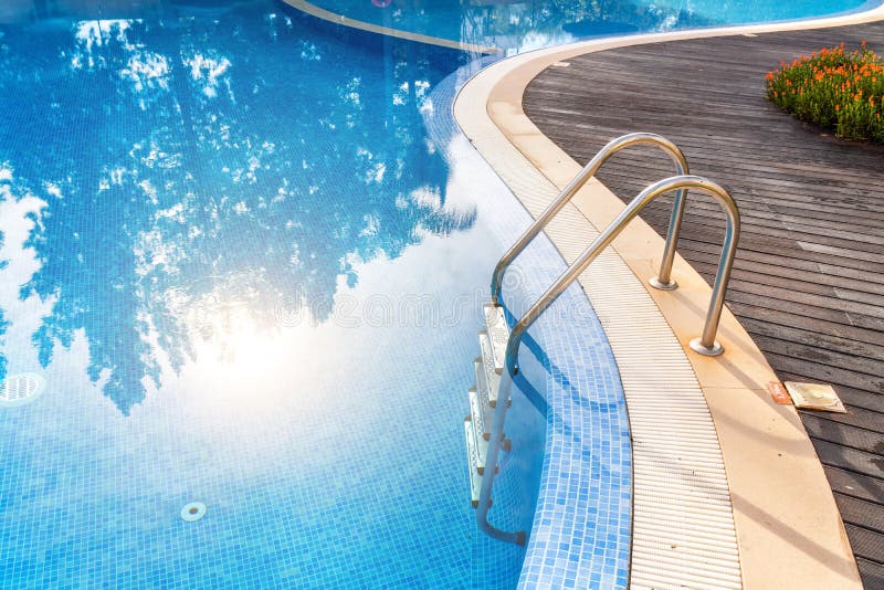 Steps into the Pool with Handrails in Water Reflex Sun. for Tourists