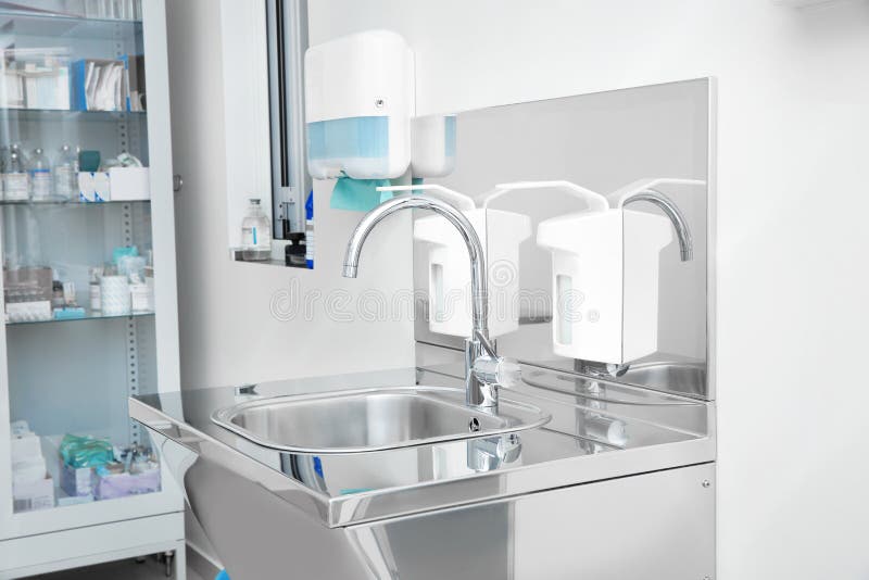Sterile steel washbasin in modern surgery stock images Sterile steel washbasin in modern surgery stock images