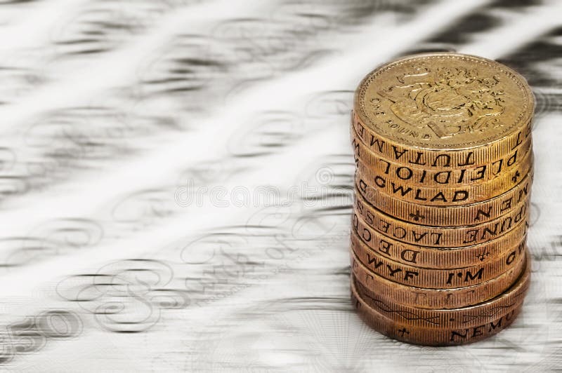 Sterling pound depreciation devaluation reduction value concept closeup macro view at UK currency stack of one pound coins royalty free stock photos