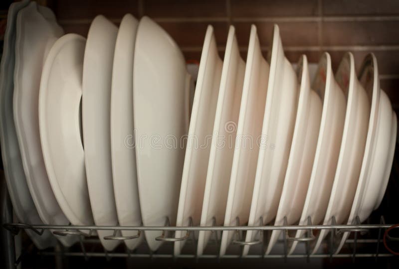 Stack of white melamine and ceramics dishes on the rack. Stack of white melamine and ceramics dishes on the rack