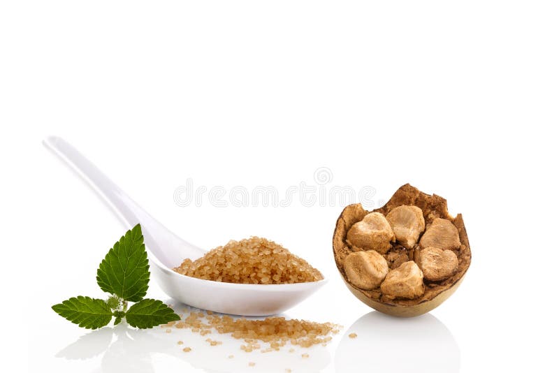 Heap of brown cane crystallized sugar in white spoon and monk fruit, luo han guo isolated on white background. Heap of brown cane crystallized sugar in white spoon and monk fruit, luo han guo isolated on white background