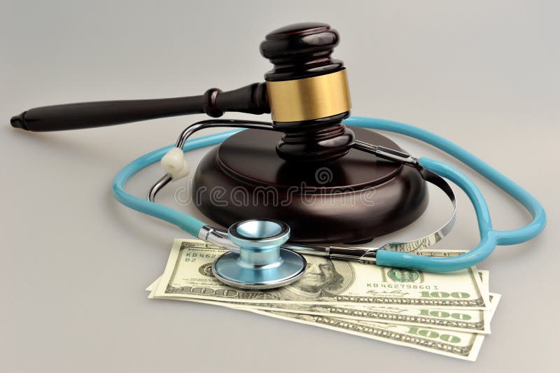 Stethoscope with judge gavel, money on gray. Stethoscope with judge gavel, money on gray