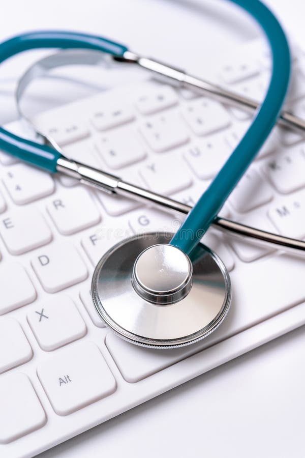 Stethoscope on computer keyboard on white background. Physician write medical case long term care treatment concept, close up