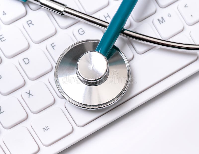 Stethoscope on computer keyboard on white background. Physician write medical case long term care treatment concept, close up