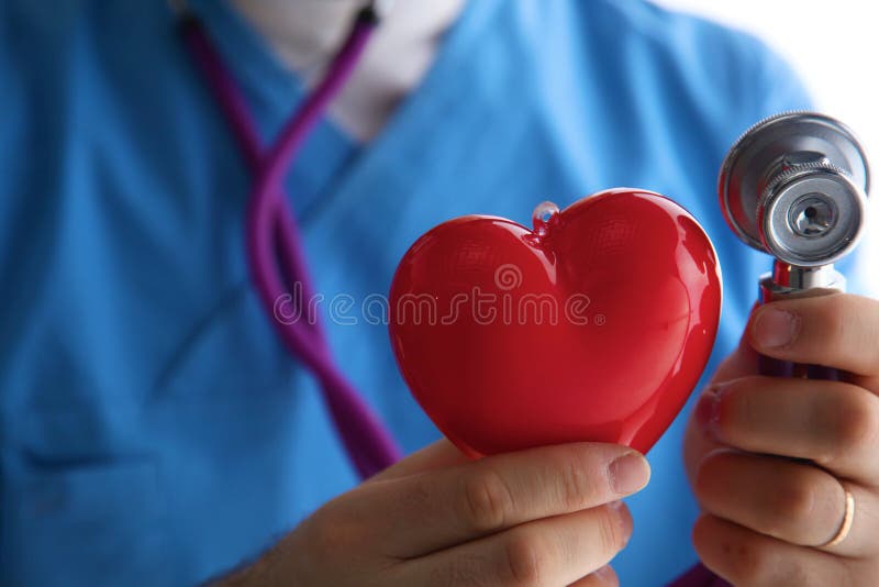 Stethoscope with heart in doctor hands, close-up