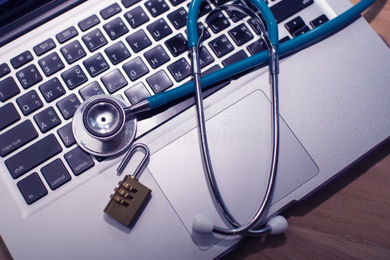 Stethoscope and key on keyboard. Unlock and repair computer concept royalty free stock photo