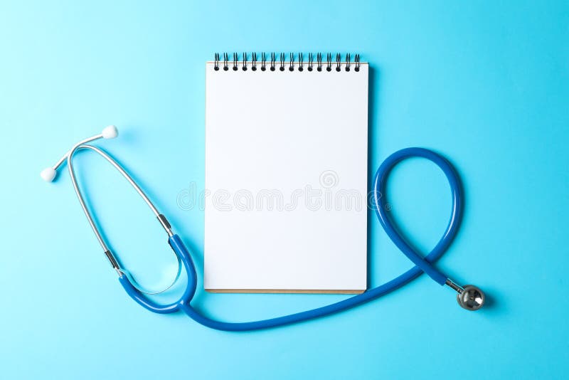 Stethoscope and notepad on a blue background stock photos Stethoscope and notepad on a blue background stock photos