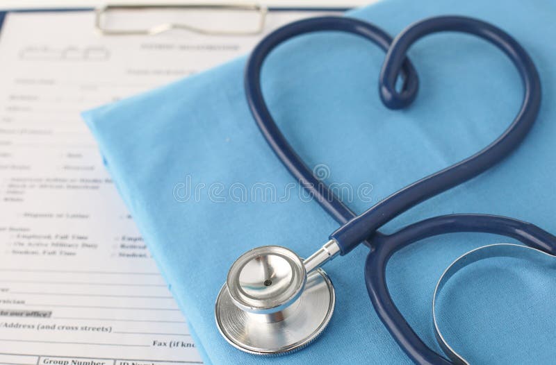 A stethoscope shaping a heart and a clipboard on a medical uniform, closeup