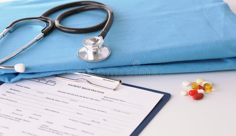 A stethoscope shaping a heart on a medical uniform, closeup