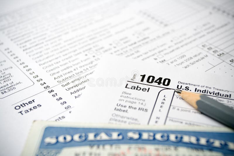 Social Security card on US 1040 tax forms and gray pencil. Social Security card on US 1040 tax forms and gray pencil