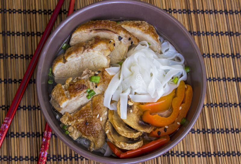 The stewed noodles with duck on bamboo background