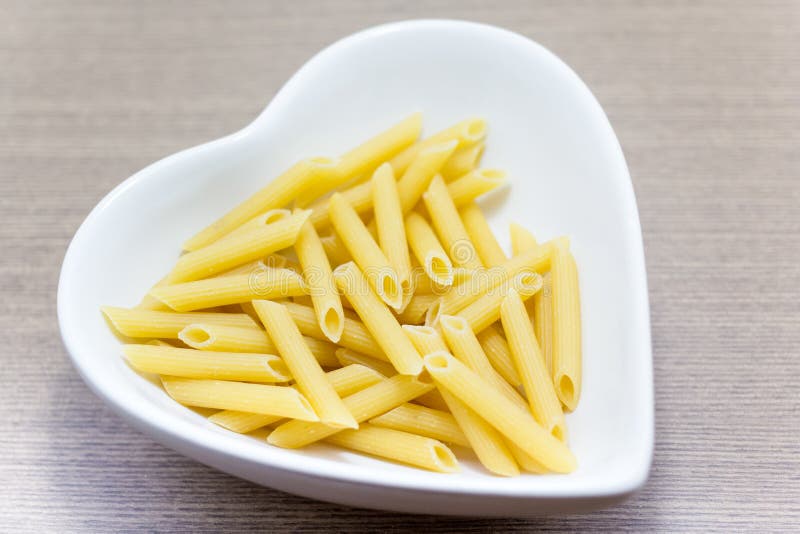 Stick Pasta in a Heart Shaped Bowl Stock Photo Image of food, yellow