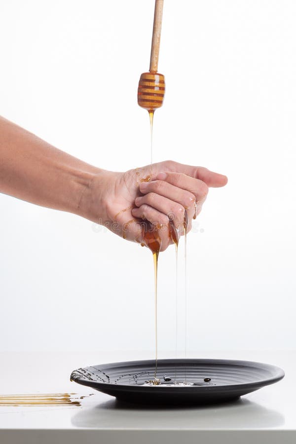 Honey from the Hand Drains into a White Plate Stock Photo Image of edible, golden 132038734
