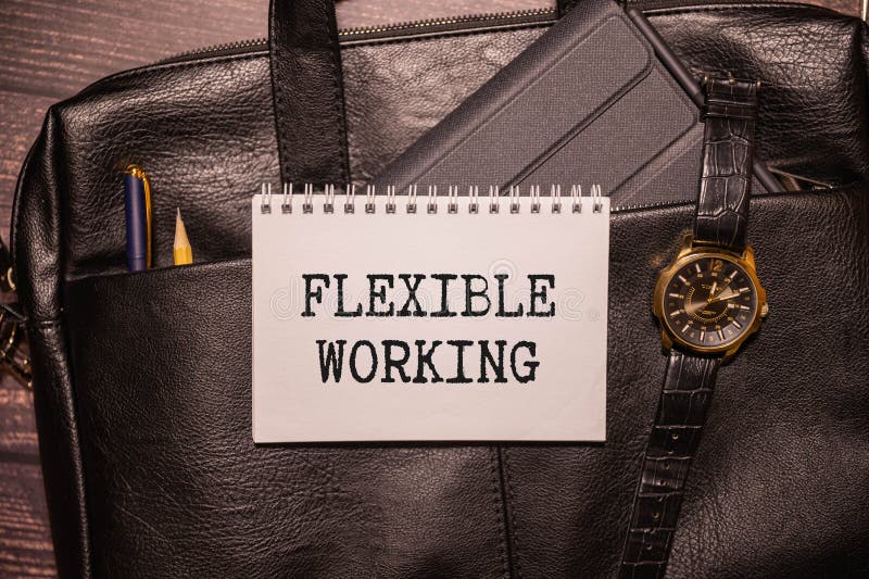 Sticker, glasses and calculator near the notepad. text FLEXIBLE WORKING royalty free stock photography