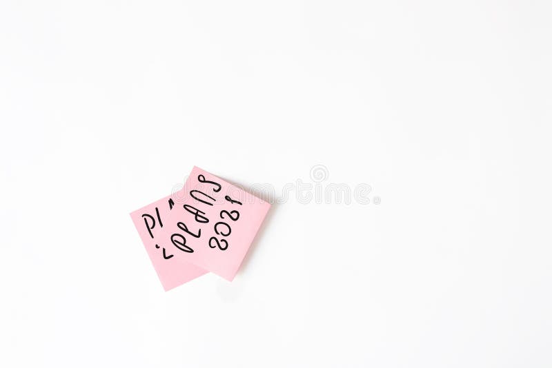 Sticker with plans for 2021 pasted over the sticker with plans for 2020. Planning concept, setting new goals stock photos