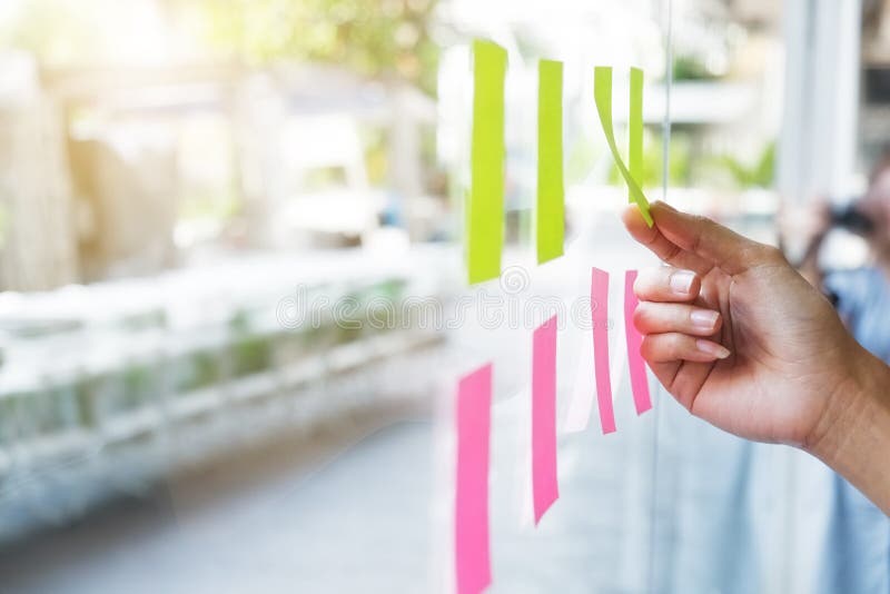 Sticky note paper reminder schedule board on glass windows.