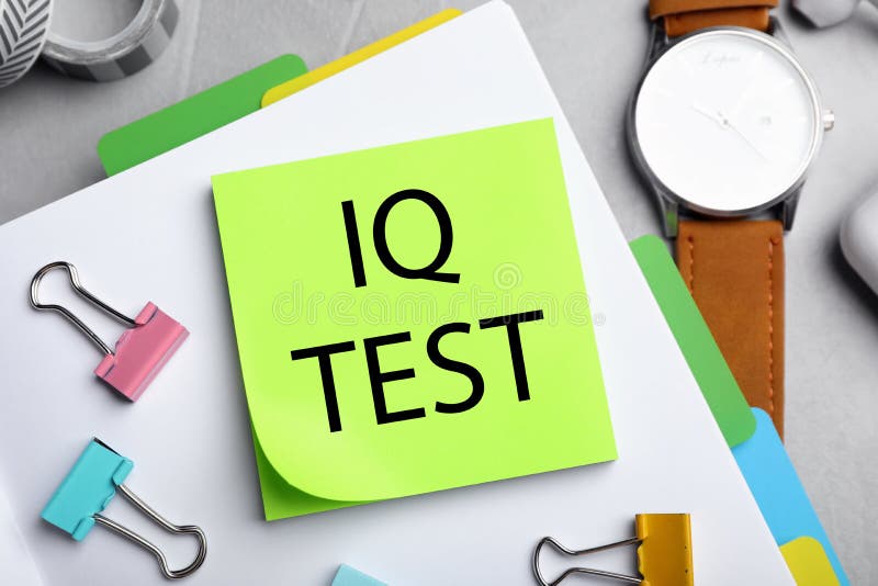 Sticky note with text IQ Test and stationery on table, flat lay