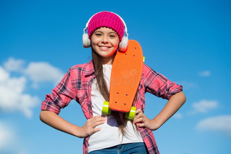 Active lifestyle. Active girl skater hold penny board sunny sky. Action sport. Recreational activity. Healthy life. Skateboarding and transportation. Summer vacation. Outdoor adventure. Active lifestyle. Active girl skater hold penny board sunny sky. Action sport. Recreational activity. Healthy life. Skateboarding and transportation. Summer vacation. Outdoor adventure.