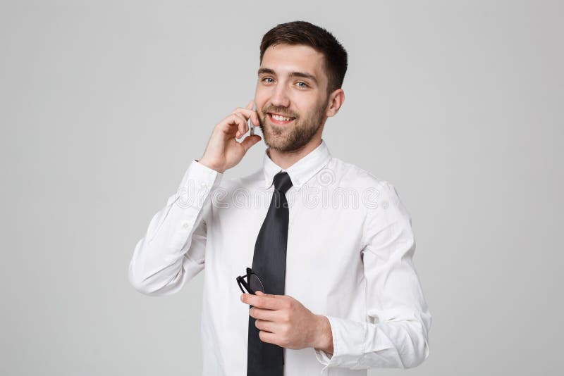 Lifestyle and Business Concept - Portrait of a handsome businessman enjoy talking with mobile phone. Isolated White background. Copy Space. Lifestyle and Business Concept - Portrait of a handsome businessman enjoy talking with mobile phone. Isolated White background. Copy Space.