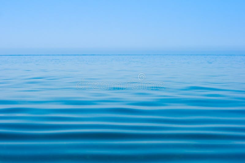 Still calm sea or ocean water surface and horizon