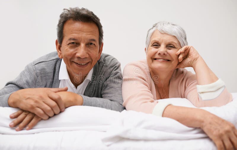 Still fun-loving. Portrait of a smiling senior couple relaxing on their bed.